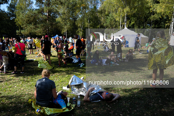 Athletes rest after running during the 17th PKO Three Mounds Run on Pilsudski Mound in Krakow, Poland, on September 22, 2024. The Three Moun...