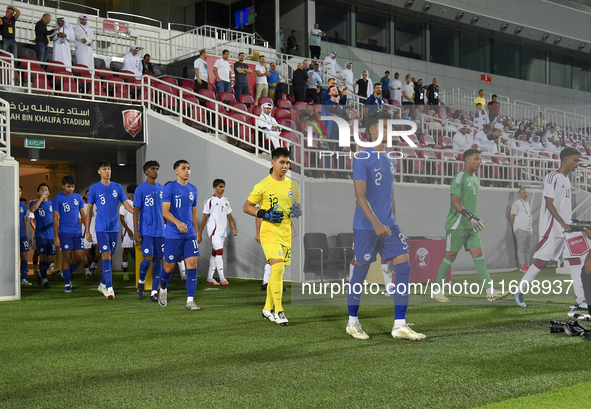 Singapore and Qatar players walk onto the pitch before the 2025 AFC U20 Asian Cup Qualifiers Group J match between Qatar and Singapore at Ab...