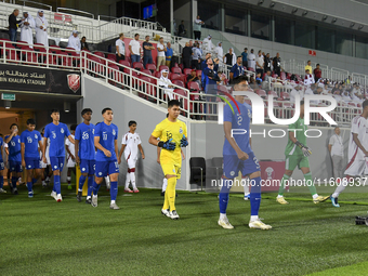 Singapore and Qatar players walk onto the pitch before the 2025 AFC U20 Asian Cup Qualifiers Group J match between Qatar and Singapore at Ab...