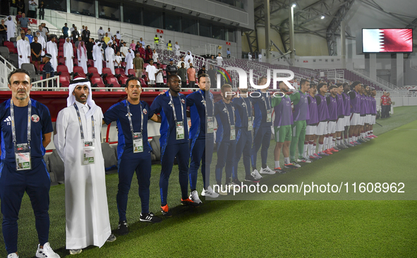 Qatar head coach Felix Angel, his staff, and substitutes line up before the 2025 AFC U20 Asian Cup Qualifiers Group J match between Qatar an...