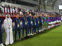 Qatar head coach Felix Angel, his staff, and substitutes line up before the 2025 AFC U20 Asian Cup Qualifiers Group J match between Qatar an...