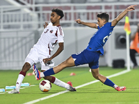 Motaman Mohamed (L) of Qatar battles for the ball with Iryan Fandi (R) of Singapore during the 2025 AFC U20 Asian Cup Qualifiers Group J mat...