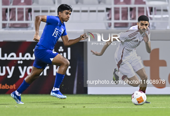 Mohamed Khaled Gouda (R) of Qatar battles for the ball with Sahoo Garv (L) of Singapore during the 2025 AFC U20 Asian Cup Qualifiers Group J...