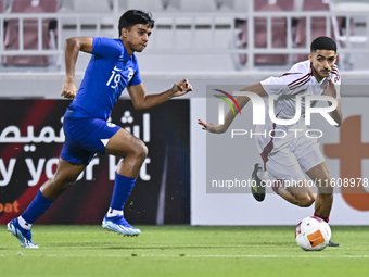 Mohamed Khaled Gouda (R) of Qatar battles for the ball with Sahoo Garv (L) of Singapore during the 2025 AFC U20 Asian Cup Qualifiers Group J...