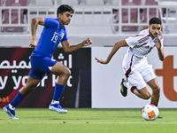 Mohamed Khaled Gouda (R) of Qatar battles for the ball with Sahoo Garv (L) of Singapore during the 2025 AFC U20 Asian Cup Qualifiers Group J...