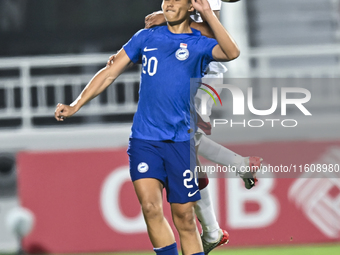 Motaman Mohamed (R) of Qatar battles for the ball with Iryan Fandi (L) of Singapore during the 2025 AFC U20 Asian Cup Qualifiers Group J mat...