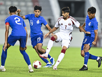 Tahsin Mohammed Jamshid (C) of Qatar battles for the ball with Sahoo Garv (2-L) of Singapore during the 2025 AFC U20 Asian Cup Qualifiers Gr...