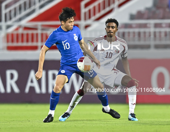 Ibrahim Mohammadali (R) of Qatar battles for the ball with Jonan Tan (L) of Singapore during the 2025 AFC U20 Asian Cup Qualifiers Group J m...