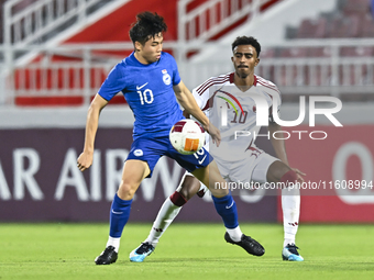 Ibrahim Mohammadali (R) of Qatar battles for the ball with Jonan Tan (L) of Singapore during the 2025 AFC U20 Asian Cup Qualifiers Group J m...