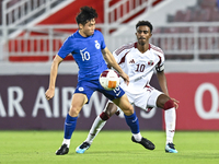 Ibrahim Mohammadali (R) of Qatar battles for the ball with Jonan Tan (L) of Singapore during the 2025 AFC U20 Asian Cup Qualifiers Group J m...