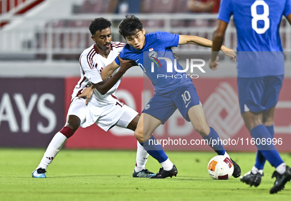 Ibrahim Mohammadali of Qatar battles for the ball with Jonan Tan of Singapore during the 2025 AFC U20 Asian Cup Qualifiers Group J match bet...