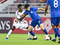 Ibrahim Mohammadali of Qatar battles for the ball with Jonan Tan of Singapore during the 2025 AFC U20 Asian Cup Qualifiers Group J match bet...