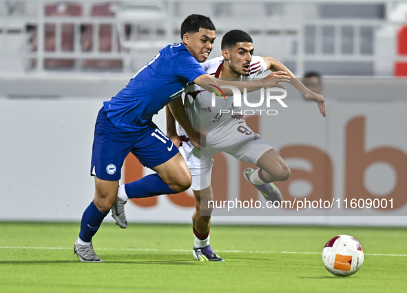 Mohamed Khaled Gouda (R) of Qatar battles for the ball with Fairuz Fazli (L) of Singapore during the 2025 AFC U20 Asian Cup Qualifiers Group...