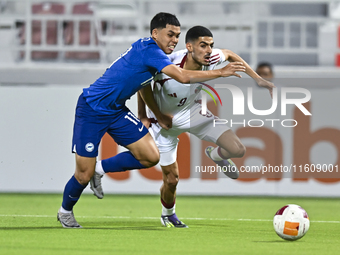 Mohamed Khaled Gouda (R) of Qatar battles for the ball with Fairuz Fazli (L) of Singapore during the 2025 AFC U20 Asian Cup Qualifiers Group...