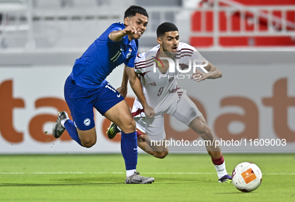 Mohamed Khaled Gouda (R) of Qatar battles for the ball with Fairuz Fazli (L) of Singapore during the 2025 AFC U20 Asian Cup Qualifiers Group...