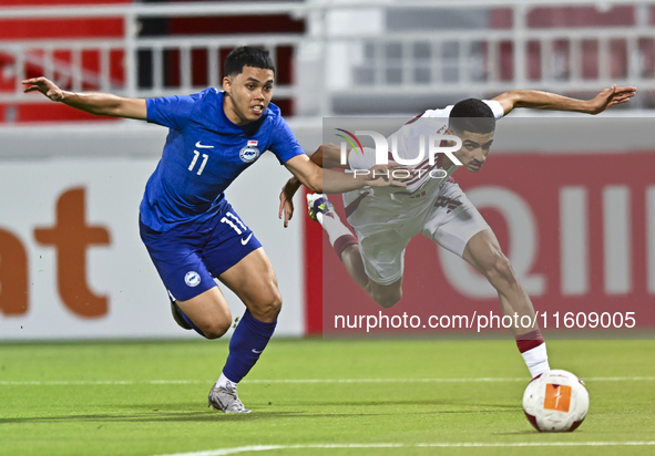 Mohamed Khaled Gouda (R) of Qatar battles for the ball with Fairuz Fazli (L) of Singapore during the 2025 AFC U20 Asian Cup Qualifiers Group...