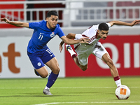 Mohamed Khaled Gouda (R) of Qatar battles for the ball with Fairuz Fazli (L) of Singapore during the 2025 AFC U20 Asian Cup Qualifiers Group...