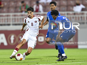 Moath Ibrahim Taha (L) of Qatar battles for the ball with Marcus Mosses (R) of Singapore during the 2025 AFC U20 Asian Cup Qualifiers Group...