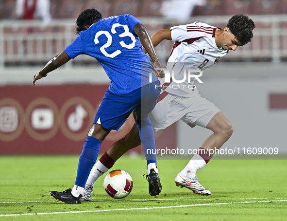 Moath Ibrahim Taha (R) of Qatar battles for the ball with Marcus Mosses (L) of Singapore during the 2025 AFC U20 Asian Cup Qualifiers Group...