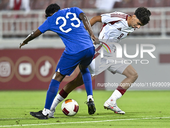 Moath Ibrahim Taha (R) of Qatar battles for the ball with Marcus Mosses (L) of Singapore during the 2025 AFC U20 Asian Cup Qualifiers Group...