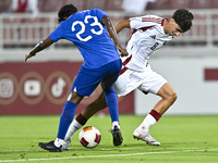 Moath Ibrahim Taha (R) of Qatar battles for the ball with Marcus Mosses (L) of Singapore during the 2025 AFC U20 Asian Cup Qualifiers Group...