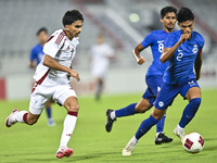 Tahsin Mohammed Jamshid (L) of Qatar battles for the ball with Raoul Suhaimi (R) of Singapore during the 2025 AFC U20 Asian Cup Qualifiers G...