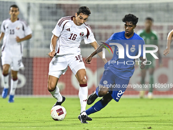 Mohamed Hani Faragalla of Qatar battles for the ball with Marcus Mosses of Singapore during the 2025 AFC U20 Asian Cup Qualifiers Group J ma...