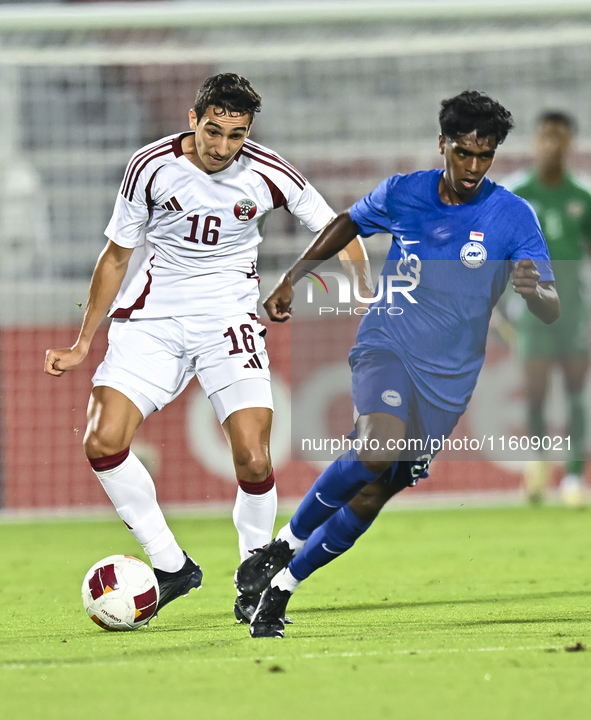 Mohamed Hani Faragalla of Qatar battles for the ball with Marcus Mosses of Singapore during the 2025 AFC U20 Asian Cup Qualifiers Group J ma...