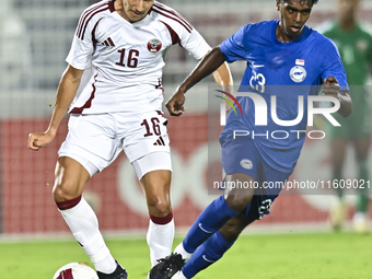 Mohamed Hani Faragalla of Qatar battles for the ball with Marcus Mosses of Singapore during the 2025 AFC U20 Asian Cup Qualifiers Group J ma...