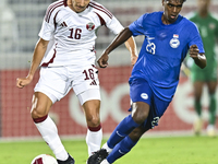 Mohamed Hani Faragalla of Qatar battles for the ball with Marcus Mosses of Singapore during the 2025 AFC U20 Asian Cup Qualifiers Group J ma...