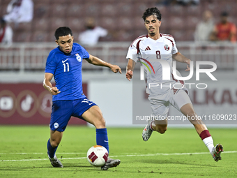 Moath Ibrahim Taha (R) of Qatar battles for the ball with Fairuz Fazli (L) of Singapore during the 2025 AFC U20 Asian Cup Qualifiers Group J...