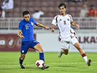 Moath Ibrahim Taha (R) of Qatar battles for the ball with Fairuz Fazli (L) of Singapore during the 2025 AFC U20 Asian Cup Qualifiers Group J...