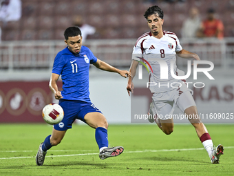 Moath Ibrahim Taha (R) of Qatar battles for the ball with Fairuz Fazli (L) of Singapore during the 2025 AFC U20 Asian Cup Qualifiers Group J...