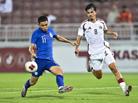 Moath Ibrahim Taha (R) of Qatar battles for the ball with Fairuz Fazli (L) of Singapore during the 2025 AFC U20 Asian Cup Qualifiers Group J...