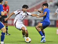 Bassam Adel Eid of Qatar battles for the ball with Sahoo Garv of Singapore during the 2025 AFC U20 Asian Cup Qualifiers Group J match betwee...