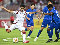 Muhammad Syazwan (L) of Qatar battles for the ball with Marcus Mosses (R) of Singapore during the 2025 AFC U20 Asian Cup Qualifiers Group J...