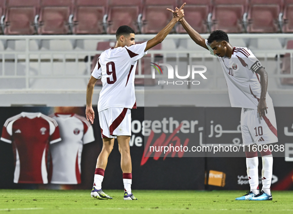 Mohamed Khaled Gouda (L) of Qatar celebrates after scoring the goal during the 2025 AFC U20 Asian Cup Qualifiers Group J match between Qatar...