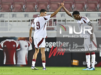 Mohamed Khaled Gouda (L) of Qatar celebrates after scoring the goal during the 2025 AFC U20 Asian Cup Qualifiers Group J match between Qatar...