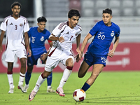 Tahsin Mohammed Jamshid (L) of Qatar battles for the ball with Iryan Fandi (R) of Singapore during the 2025 AFC U20 Asian Cup Qualifiers Gro...