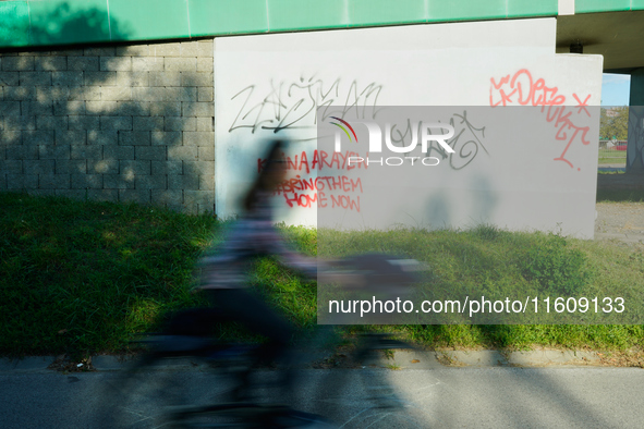 Graffiti calling for the return of Israeli hostages held by Hamas militants is seen painted on structures in Warsaw, Poland on 25 September,...