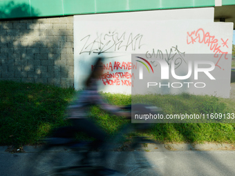 Graffiti calling for the return of Israeli hostages held by Hamas militants is seen painted on structures in Warsaw, Poland on 25 September,...