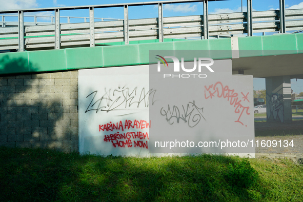 Graffiti calling for the return of Israeli hostages held by Hamas militants is seen painted on structures in Warsaw, Poland on 25 September,...