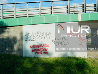 Graffiti calling for the return of Israeli hostages held by Hamas militants is seen painted on structures in Warsaw, Poland on 25 September,...