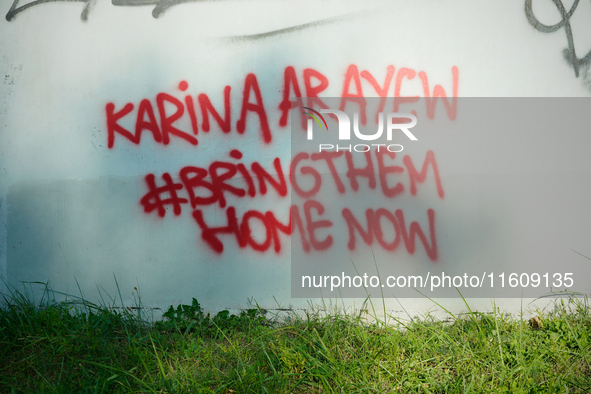 Graffiti calling for the return of Israeli hostages held by Hamas militants is seen painted on structures in Warsaw, Poland on 25 September,...