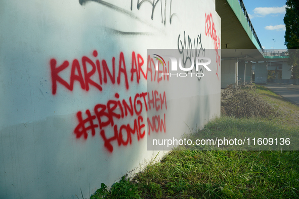 Graffiti calling for the return of Israeli hostages held by Hamas militants is seen painted on structures in Warsaw, Poland on 25 September,...