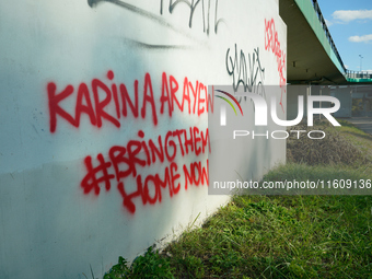 Graffiti calling for the return of Israeli hostages held by Hamas militants is seen painted on structures in Warsaw, Poland on 25 September,...