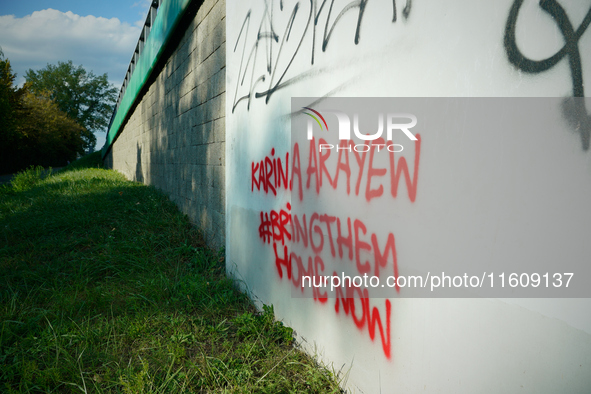 Graffiti calling for the return of Israeli hostages held by Hamas militants is seen painted on structures in Warsaw, Poland on 25 September,...