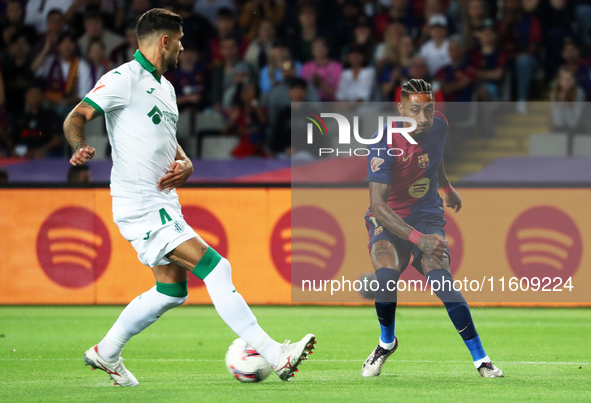 Raphinha Dias and Juan Berrocal play during the match between FC Barcelona and Getafe CF, corresponding to week 7 of LaLiga EA Sports, at th...