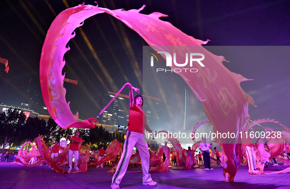 A mass performance celebrates the 75th anniversary of the founding of New China in Handan, China, on September 25, 2024. 