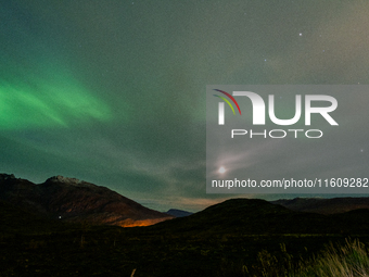 The Aurora Borealis, commonly known as the Northern Lights, are seen with the half-moon in the sky near Tromso, Norway, on September 25, 202...